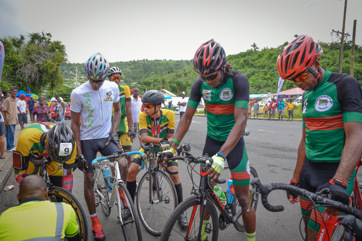 L-R Chester Letang, a member of the Grenada cycling team, Kohath Baron, Bram Sanderson, and Ellison Roudette gather prior to the start of the 2018 OECS Cycling Championship in Dominica, July 1, 2018.