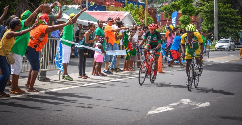 Dominica's Benjamin Daniel and Ellison Roudette sprint to the finish line during the 2018 Organization of Eastern Caribbean States Cycling Championship in Dominica, July 1, 2018. Six OECS countries participated in the nearly 60-mile long event hosted by the DCA.